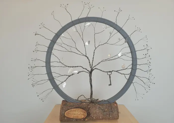 Ett pris i metall som ett hjul med ett träd och en nyckel.